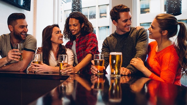 Eine Gruppe von Freunde genießen ein Bier in der Bar.  | Bild: picture alliance / PantherMedia | Graham Oliver