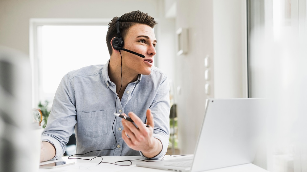 Ein junger Mann diskutiert während eines Meetings im Homeoffice per Videoanruf über Laptop. Teamfähigkeit ist eine der wichtigsten Eigenschaften, die Arbeitgeber an ihren Mitarbeitern schätzen. | Bild: picture-alliance