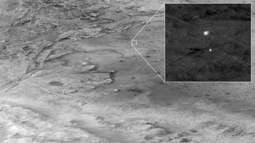 Die Landung des neuen Kollegen auf dem Mars wurde auch von einer anderen Mars-Mission beobachtet: Der Mars Reconaissance Orbiter MRO fotografiert Perseverance in seiner Landekapsel, als er am Fallschirm auf den Krater Jerezo zu anflog. | Bild: NASA